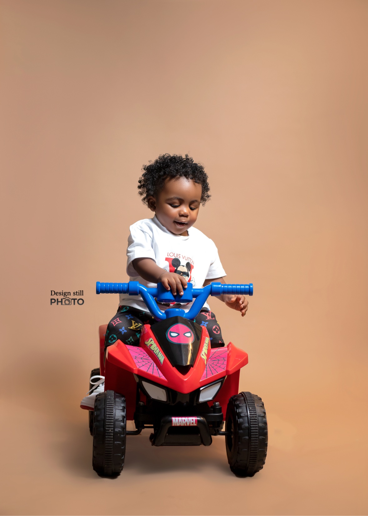 Toddler on a red toy quad