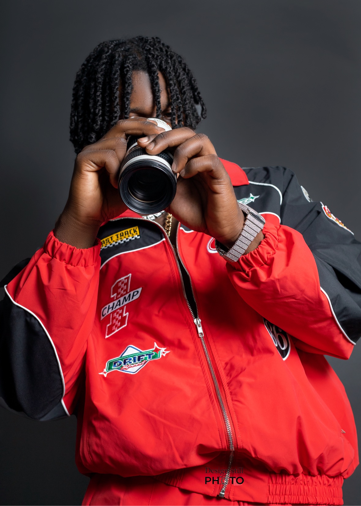Studio portrait holding a camera lens