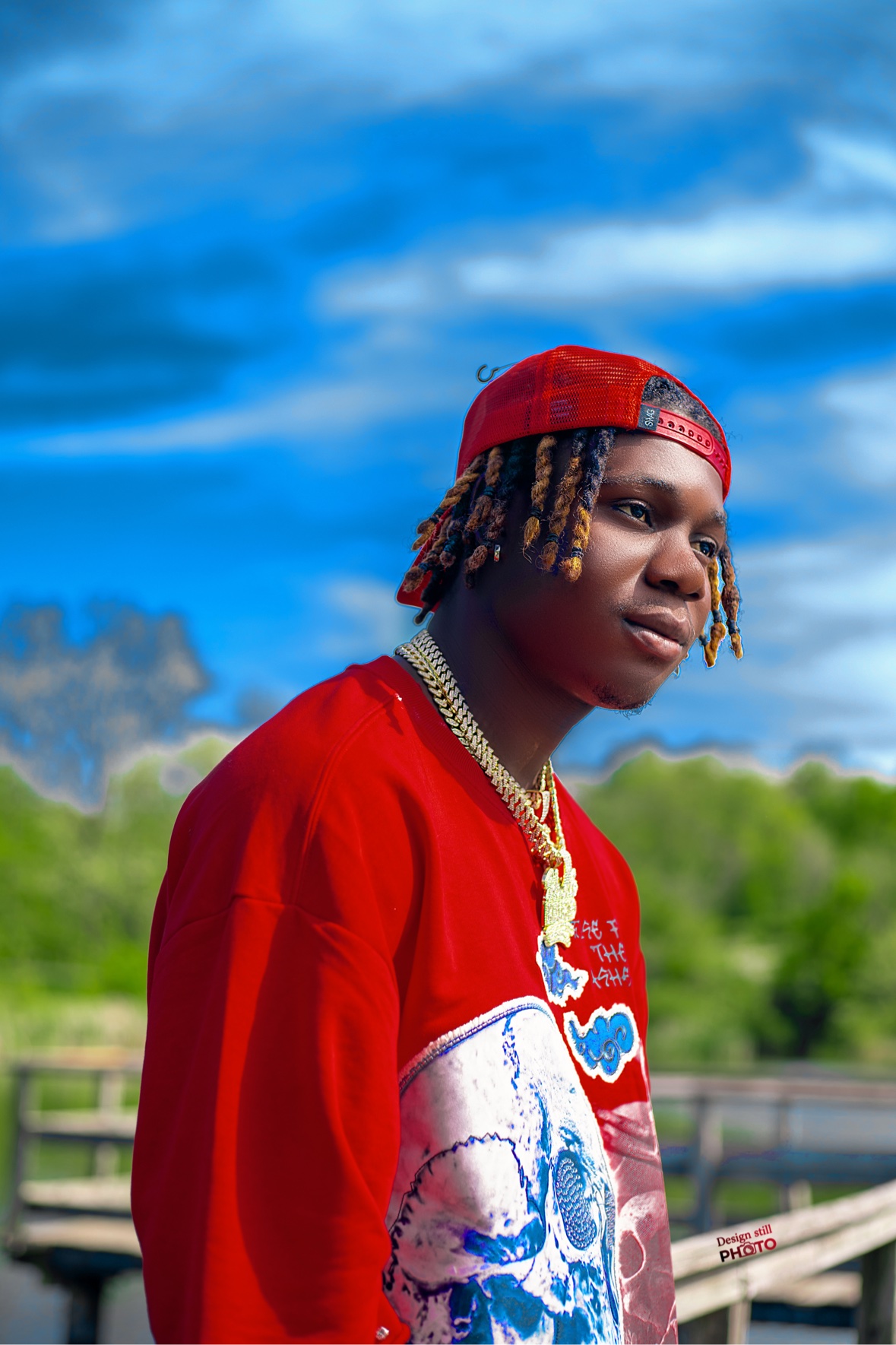 Outdoor portrait of a young man in a red cap and red shirt